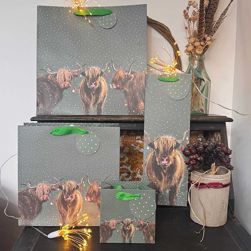 Alex Clark Highland Cows Christmas wine bottle gift bag featuring festive cattle artwork and soft ribbon handles