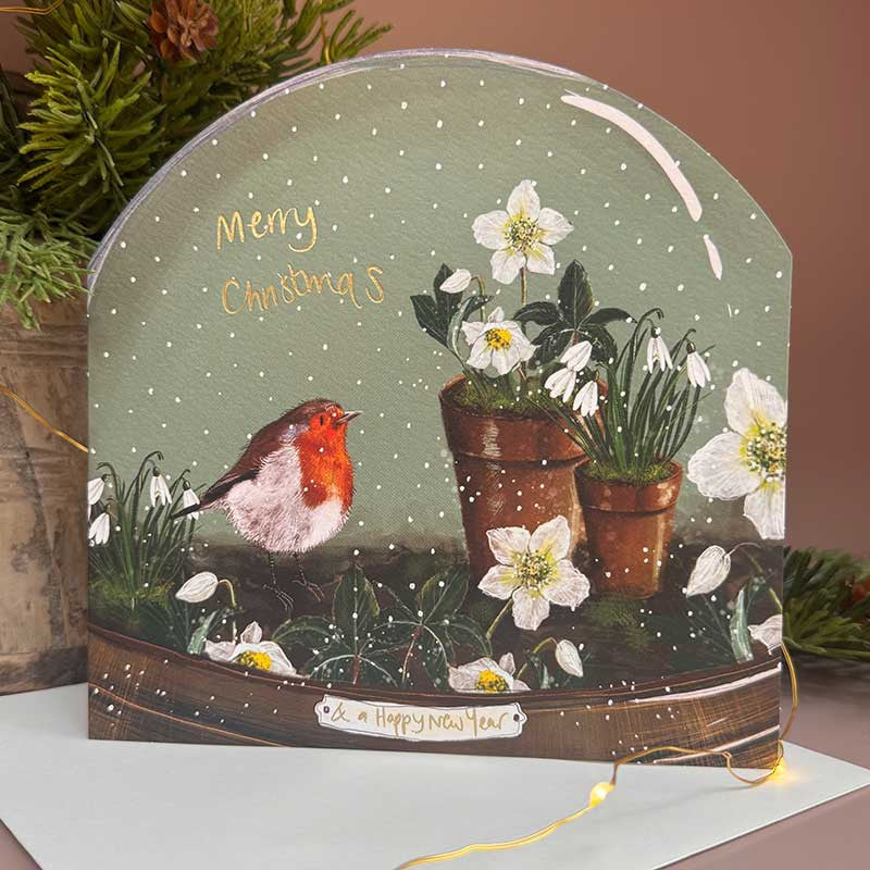 Alex Clark Robin & Pots Snow Globe greeting card depicting a robin on garden pots in a snowy scene with a white envelope.