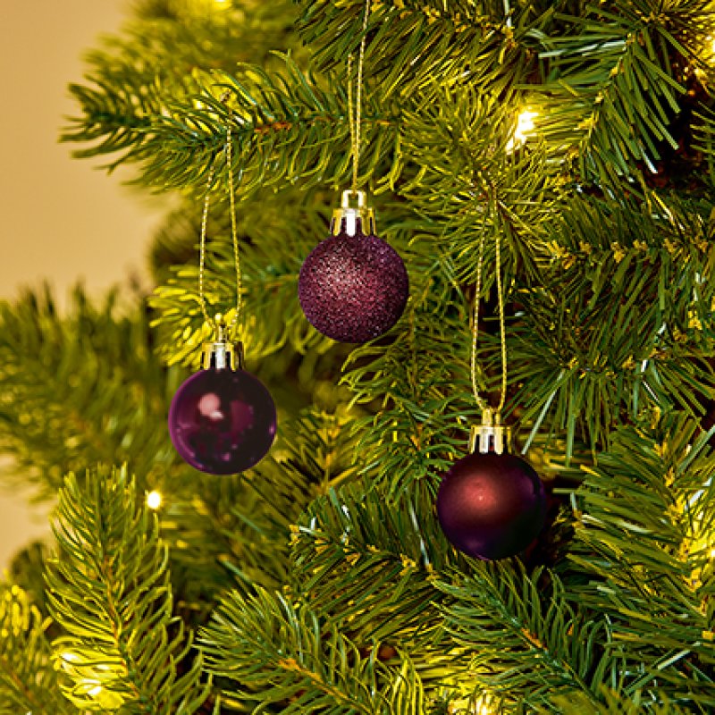 Premier 24 x 30mm Plum Finish Shatterproof Baubles displayed on a green Christmas tree branch