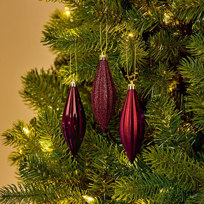 Premier 6 x 11cm Plum Shatterproof Drop Ornaments hanging on a pine Christmas tree branch