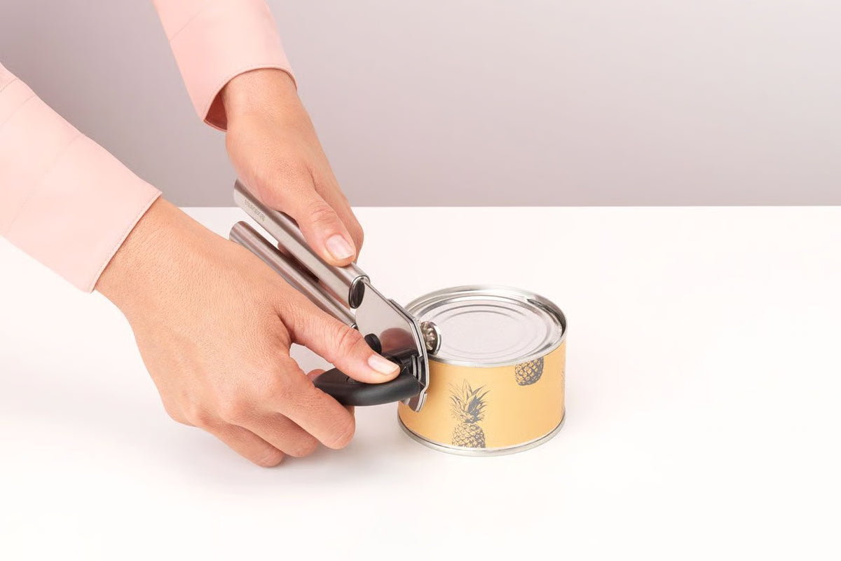 Brabantia Profile stainless steel can opener opening a tin effortlessly on a kitchen counter