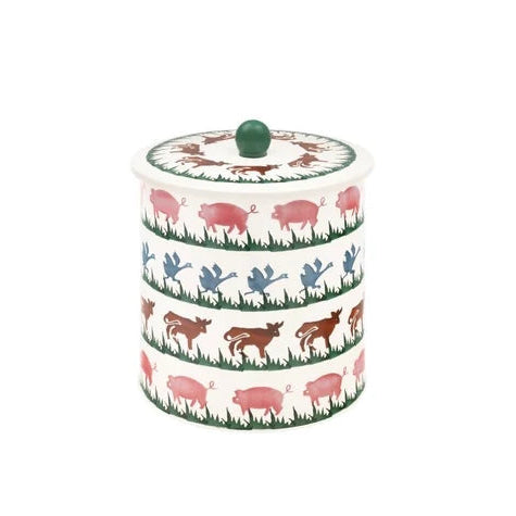 Cream Emma Bridgewater Farm Animals metal biscuit barrel featuring rows of pigs, ducks, and cows with a green lid knob.