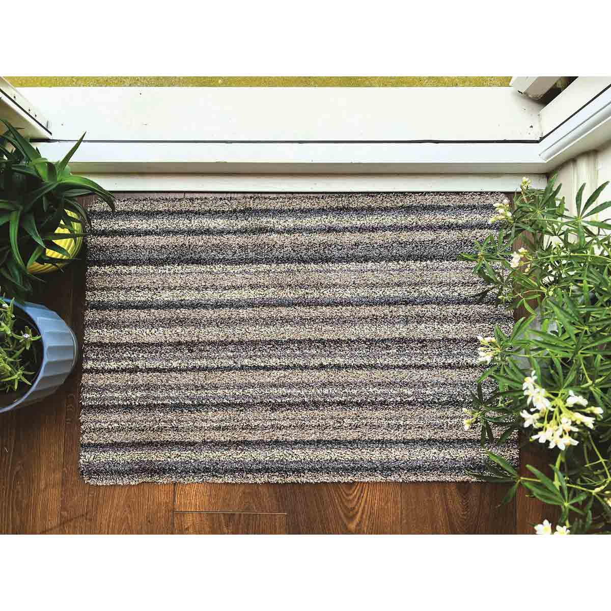 My Mat Cotton Ribbon Grey indoor doormat with striped pattern laid by a doorway