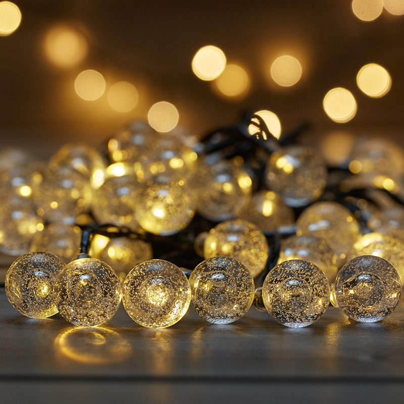 Smart Garden 100 warm white LED bubble globe rechargeable string lights glowing on a flat surface.