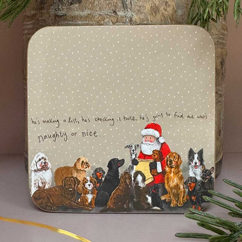 Alex Clark Naughty Or Nice festive drink coaster with cork backing on a table surface