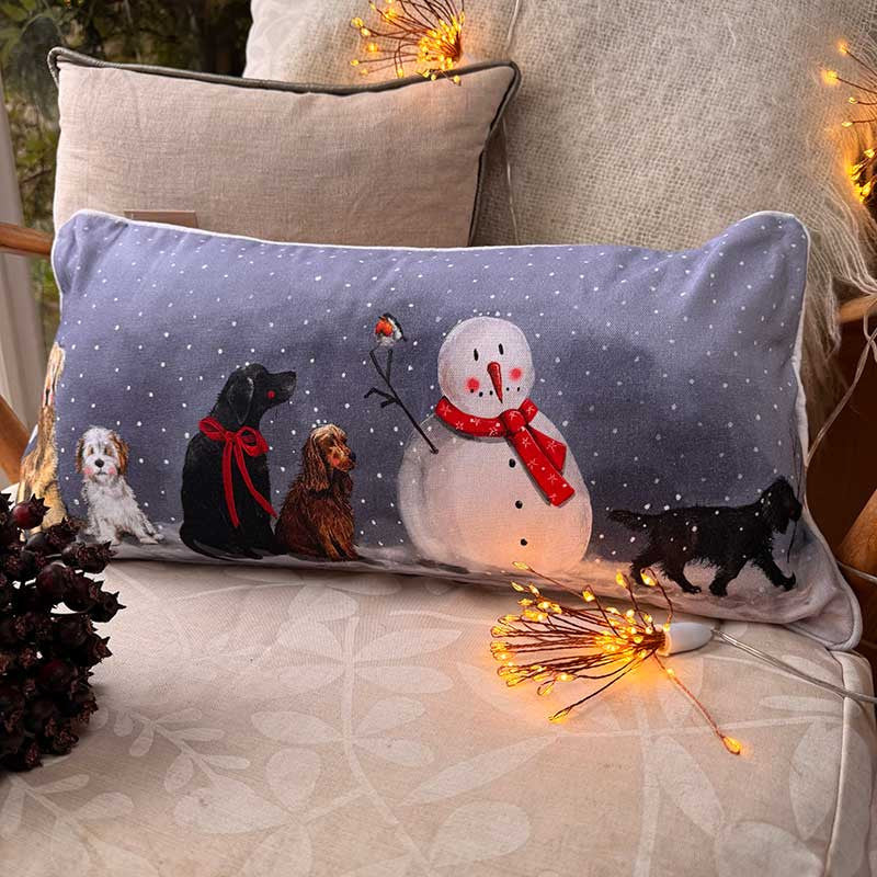 Alex Clark Dogs & Snowman Christmas cushion featuring festive dog and snowman illustrations