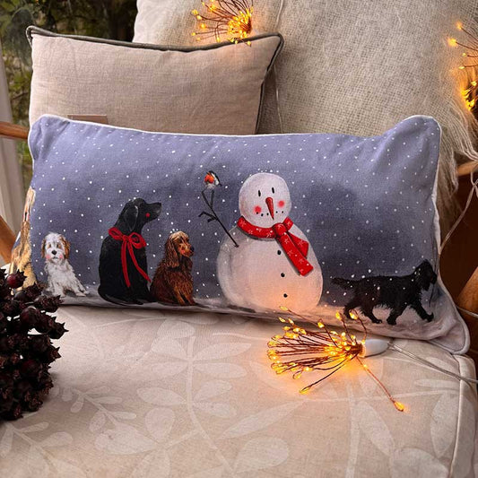 Alex Clark Dogs & Snowman Christmas cushion featuring festive dog and snowman illustrations
