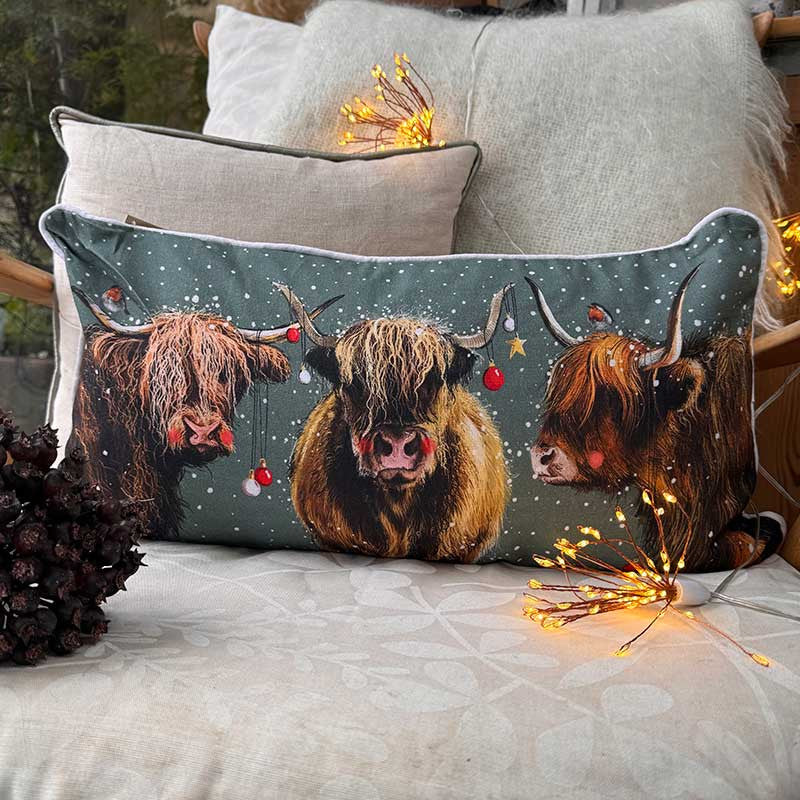 Alex Clark Highland Cows Christmas cushion featuring festive countryside cow illustrations