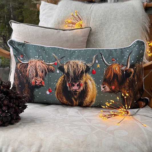 Alex Clark Highland Cows Christmas cushion featuring festive countryside cow illustrations