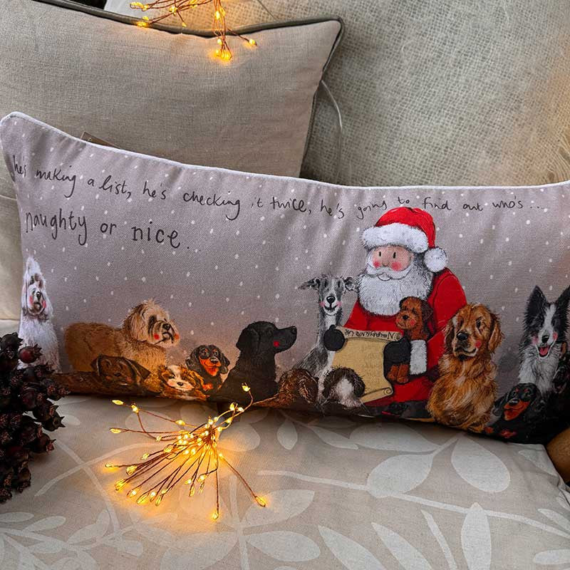 Alex Clark Naughty Or Nice Christmas cushion featuring festive animal illustrations