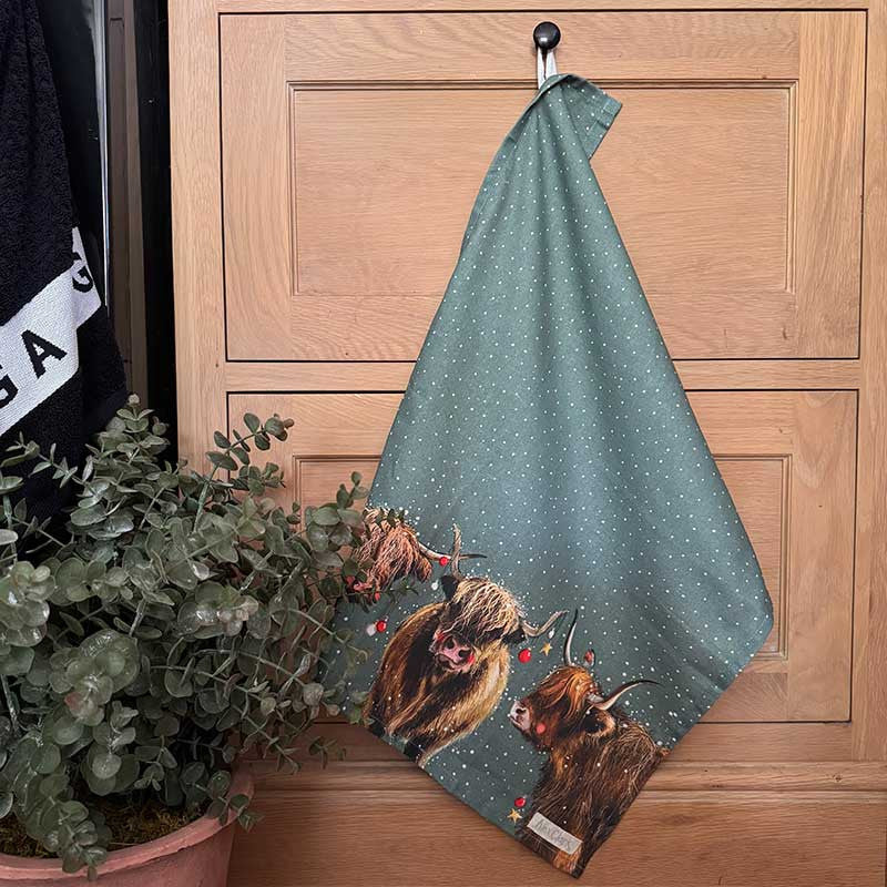 Alex Clark Highland Cows Christmas cotton tea towel featuring festive countryside cow illustrations
