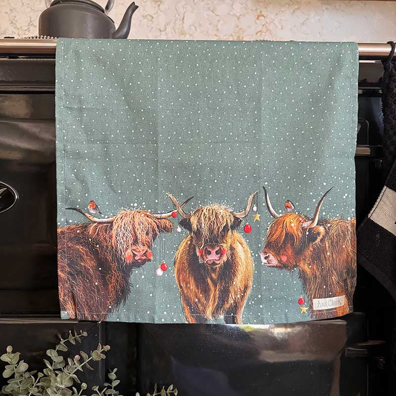 Alex Clark Highland Cows Christmas cotton tea towel featuring festive countryside cow illustrations