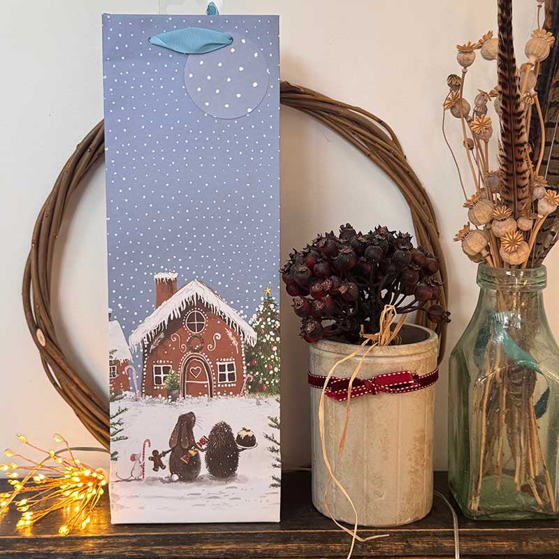 Alex Clark Gingerbread Village wine bottle gift bag featuring festive Christmas village artwork and ribbon handles
