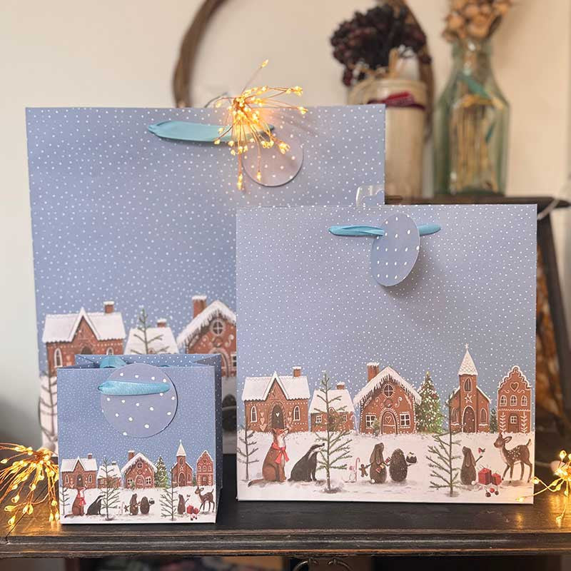Alex Clark Gingerbread Village gift bag featuring festive Christmas village artwork and ribbon handles
