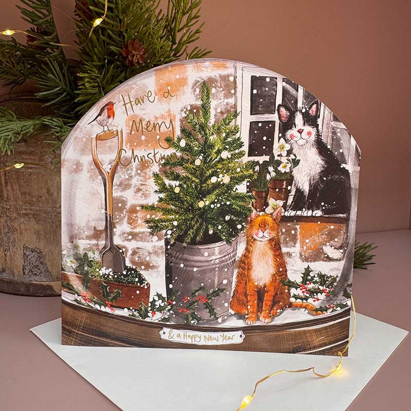 Alex Clark Cats and Christmas Tree Snow Globe greeting card depicting playful cats around a festive tree with a white envelope.