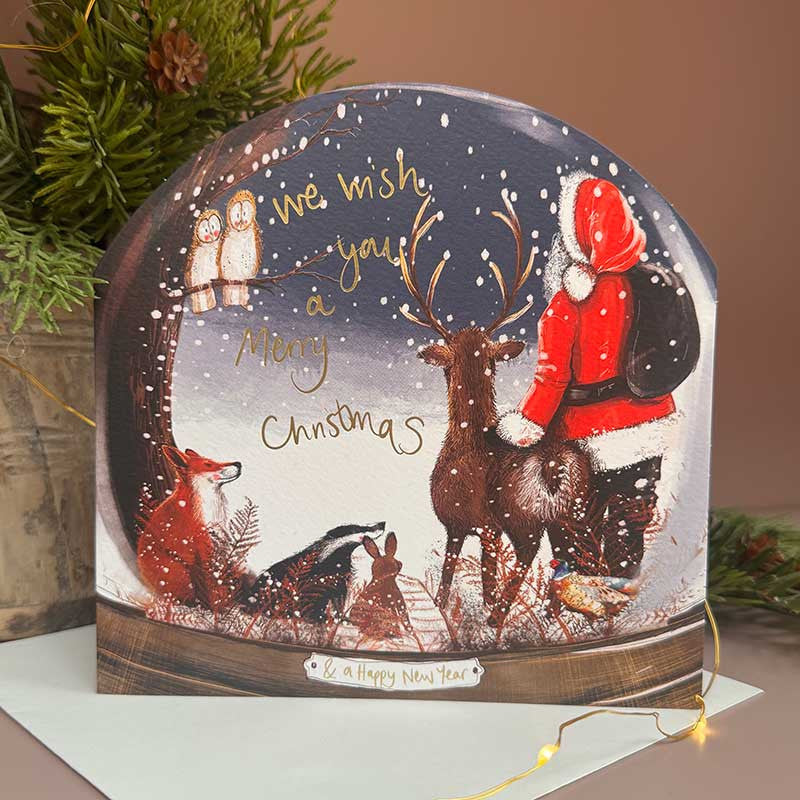 Alex Clark Santa & His Friends Snow Globe greeting card depicting Santa and woodland animals with a white envelope.