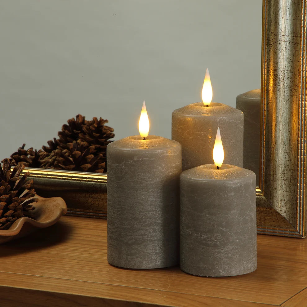 Noma set of 3 pewter flameless LED pillar candles displaying a warm flickering flame effect