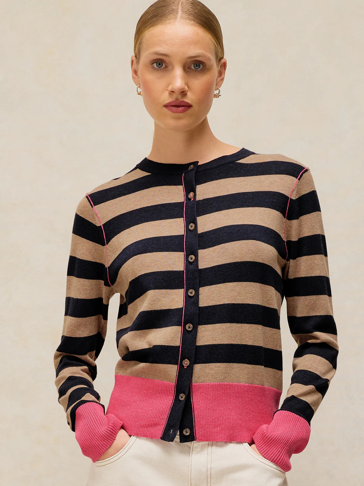 Studio shot of the White Stuff Lois Stripe Cardigan in a regular fit, highlighting the contrast stripe detail, crew neckline, and long sleeves.