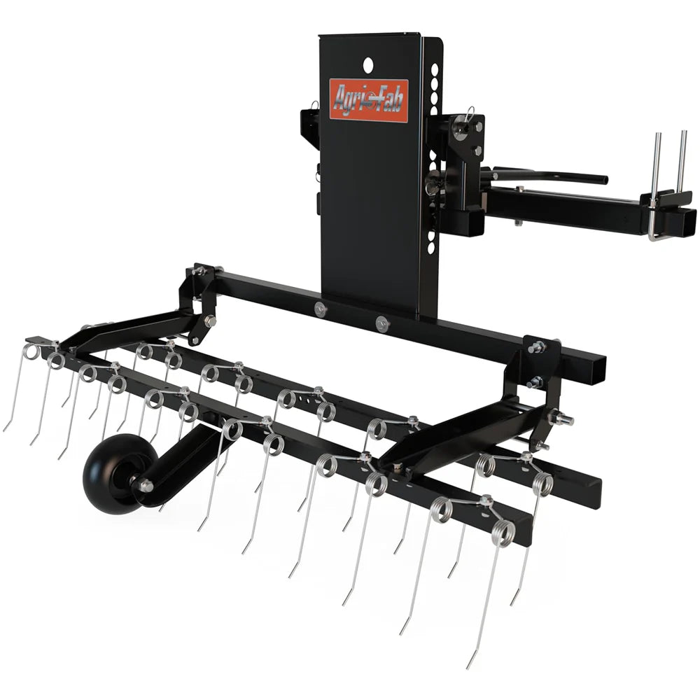 Agri-Fab 45-0629 front-mounted ZT dethatcher attachment showing heavy-duty steel construction, dual rows of spring tines, and an integrated foot lever.