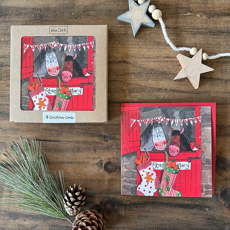 Alex Clark Christmas Stable boxed greeting card set showing illustrated festive farm animal cards and white envelopes in a box.