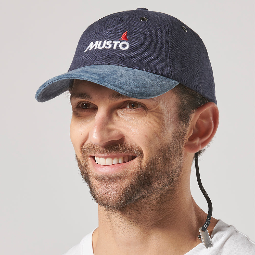 Musto Evolution Original Crew Cap in cotton, featuring a suede peak, ventilation eyelets, and a secure hat retainer clip.