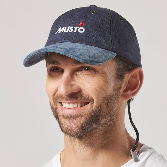 Musto Evolution Original Crew Cap in cotton, featuring a suede peak, ventilation eyelets, and a secure hat retainer clip.