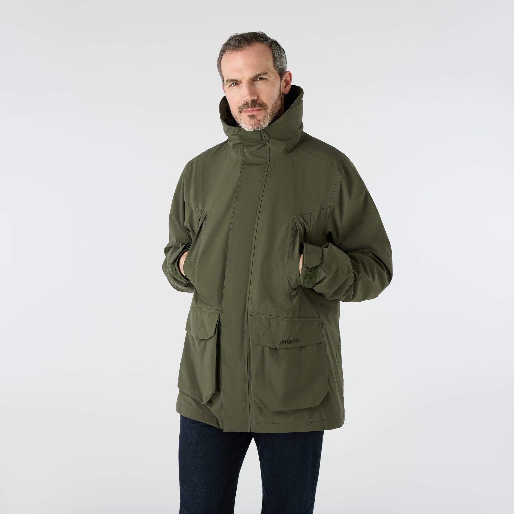 Musto Men's Fenland Jacket 3.0 in Deep Green, featuring a waterproof outer, practical pockets, and a classic zip front with storm flap.