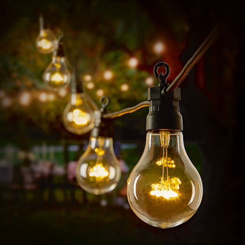 Premier 20 non-connectable festoon light string with warm white LED bulbs hanging on a garden patio