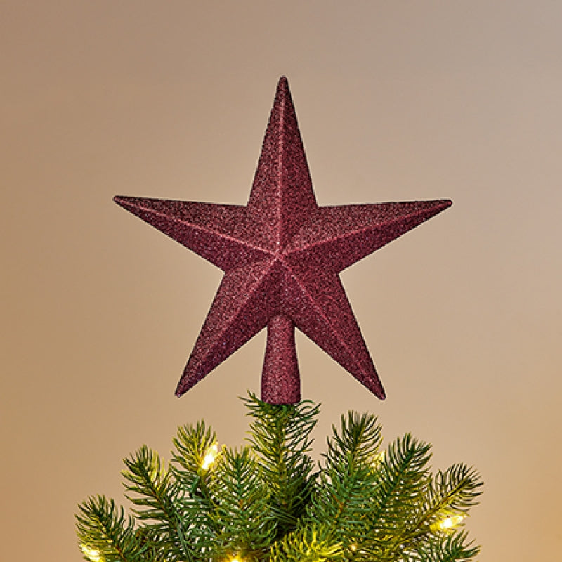 Premier 20cm Tree Top Shatterproof Star with glitter finish mounted on top of a pine Christmas tree<