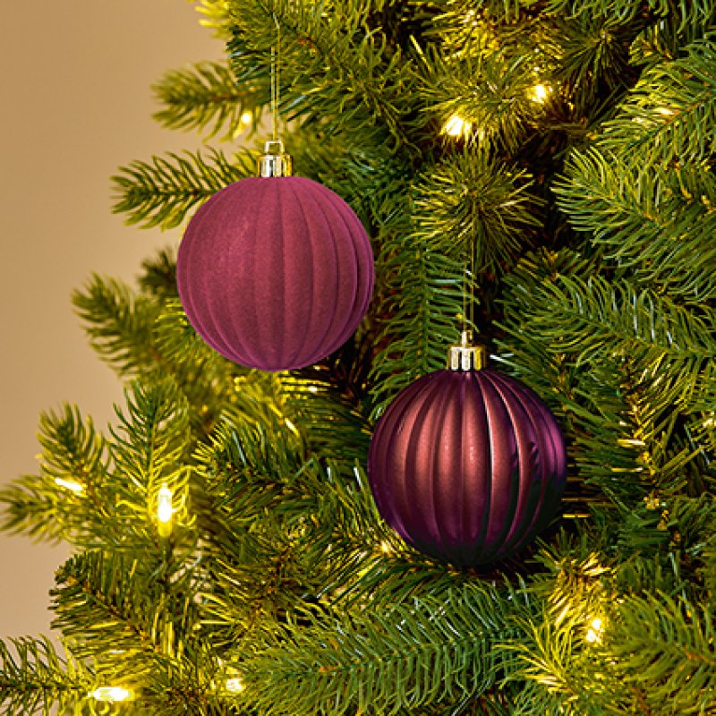 Premier 4 x 80mm Plum Flock and Matt Pumpkin Shatterproof Baubles hanging on a pine Christmas tree