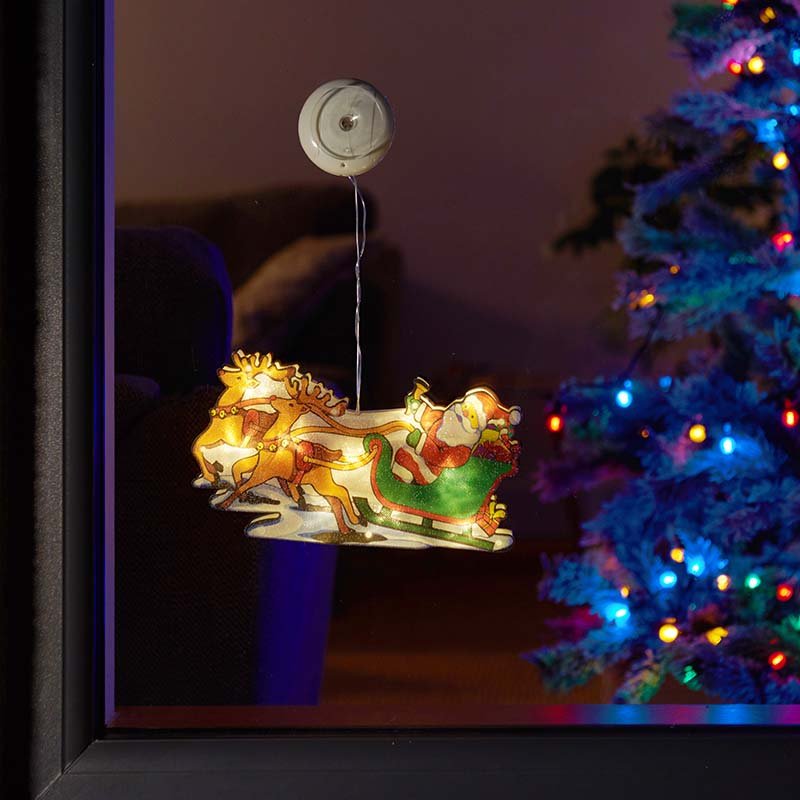 Smart Garden Vintage Window Sleigh decoration glowing with warm LED light in a window.