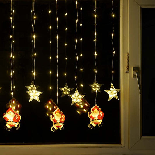 Smart Garden Warm White Xmas Star Santa Curtain Lights hanging illuminated in a window