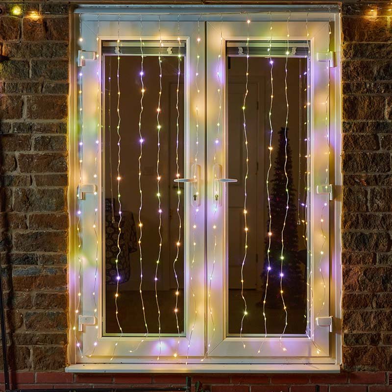 Smart Garden TwoTone Curtain Net Lights 200 LED in warm white and multicolour mode displayed on a window