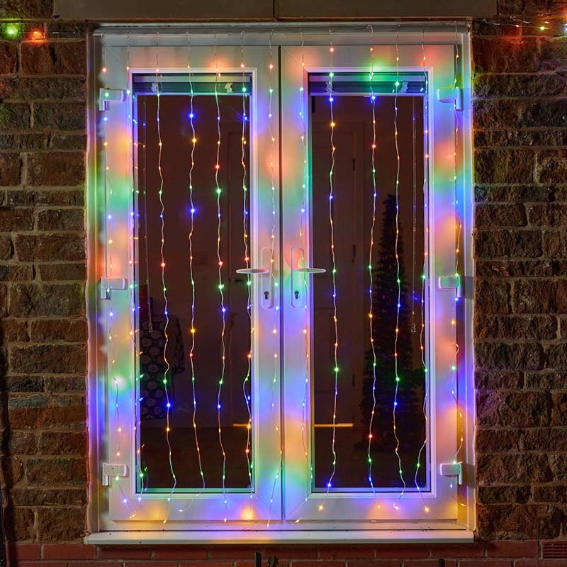 Smart Garden TwoTone Curtain Net Lights 200 LED in warm white and multicolour mode displayed on a window