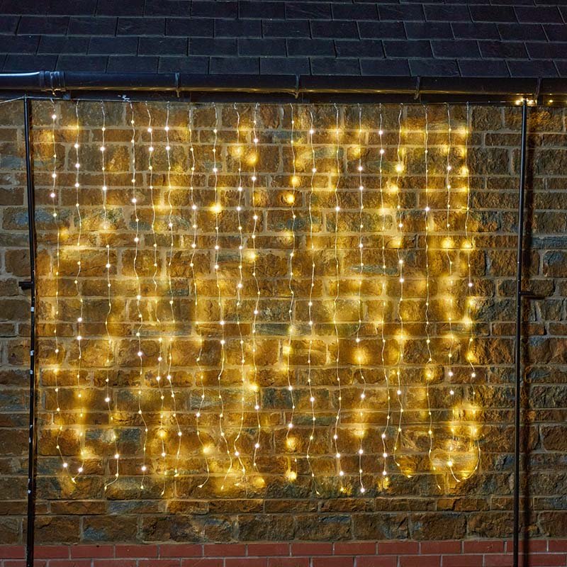 Smart Garden TwoTone Curtain Net Lights 200 LED in warm white and multicolour mode displayed on a window