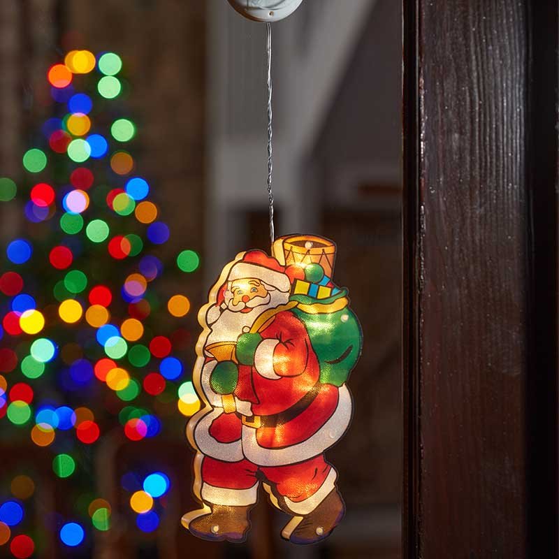 Smart Garden Vintage Window Santa decoration glowing with warm LED light in a window.