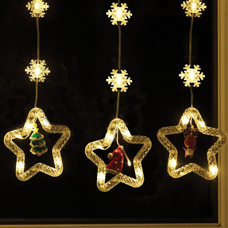 Smart Garden Warm White Xmas Star Curtain Lights hanging illuminated in a window