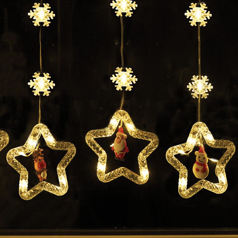 Smart Garden Warm White Xmas Star Curtain Lights hanging illuminated in a window