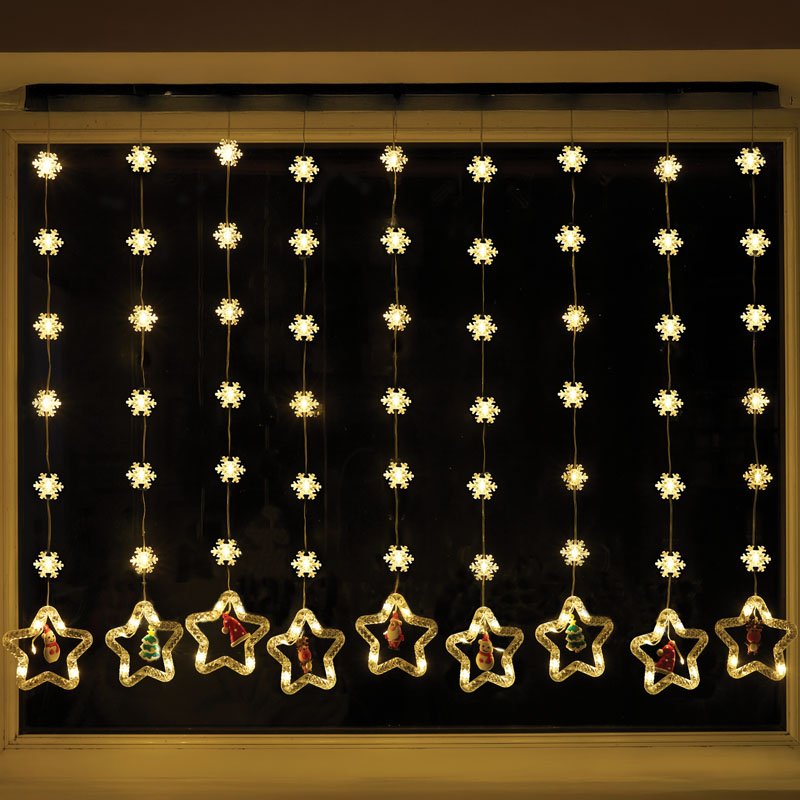 Smart Garden Warm White Xmas Star Curtain Lights hanging illuminated in a window