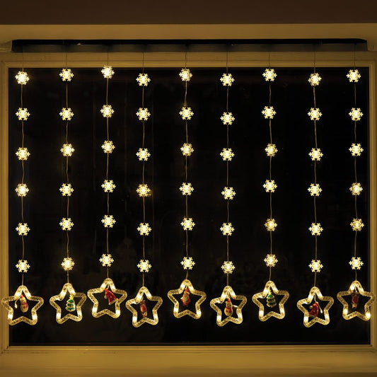 Smart Garden Warm White Xmas Star Curtain Lights hanging illuminated in a window