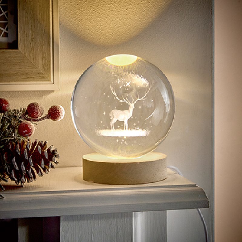 Premier 10cm USB lit etched glass ball featuring a reindeer design with warm white LED lighting