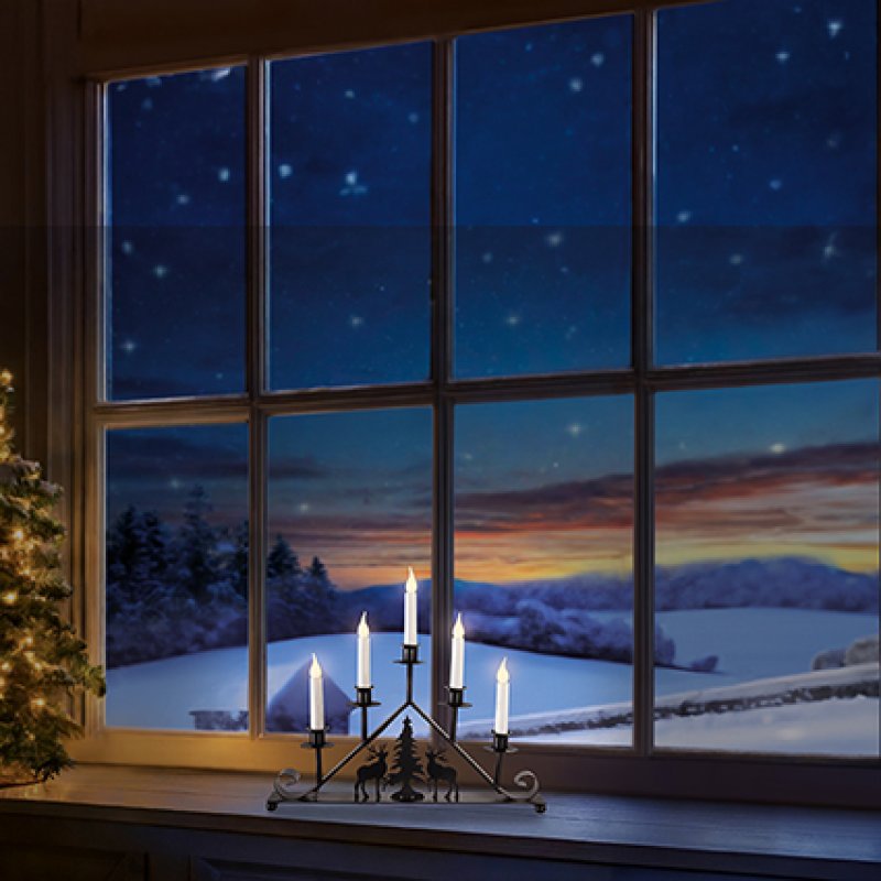 Premier 39cm battery operated black metal taper candle bridge with reindeer and tree silhouette illuminated by warm white LEDs