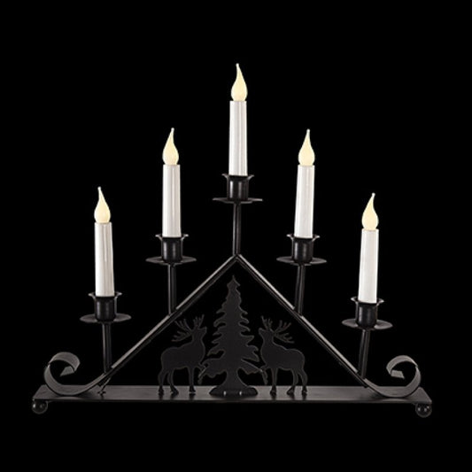 Premier 39cm battery operated black metal taper candle bridge with reindeer and tree silhouette illuminated by warm white LEDs