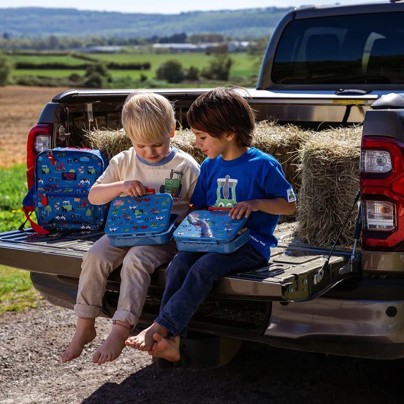 Tractor Ted Farmyard Lunch Box featuring green farm machinery graphics on the front lid<