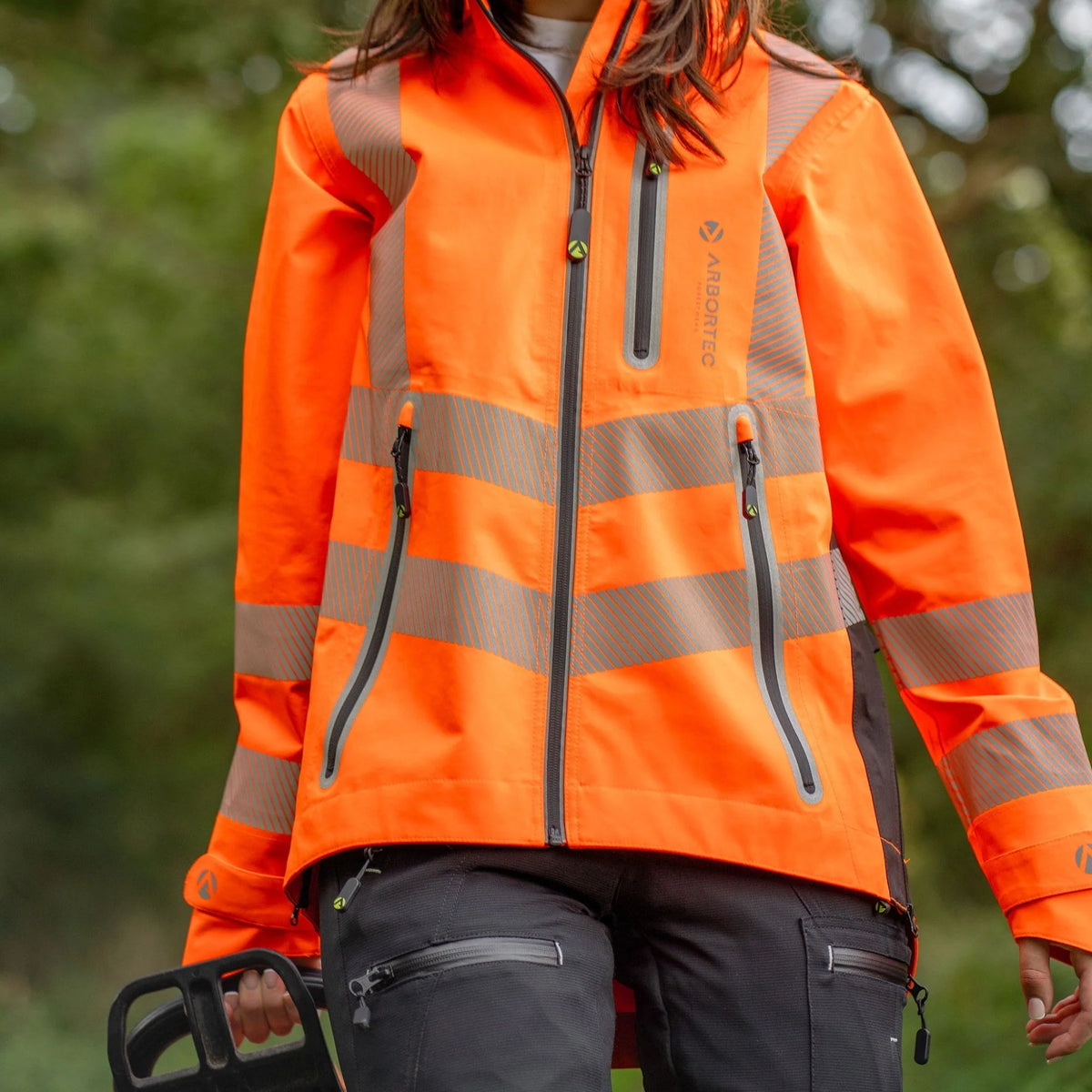 Arbortec ATHV4420 BreatheDry women's high-visibility orange waterproof railway and arborist work jacket with reflective tape detailing