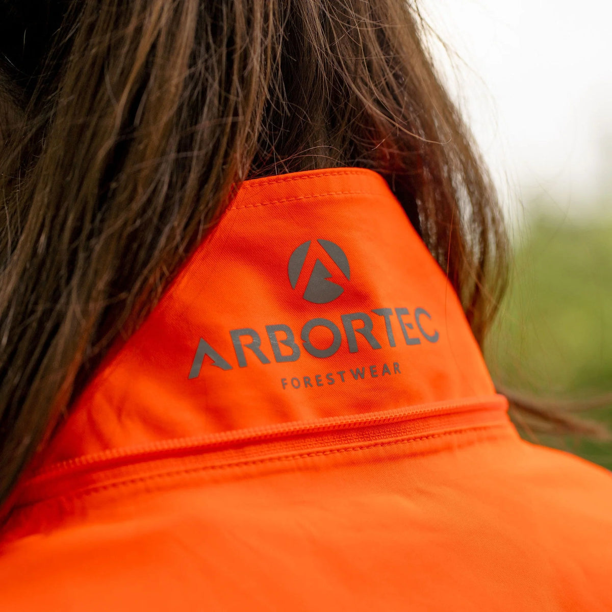 Arbortec ATHV4420 BreatheDry women's high-visibility orange waterproof railway and arborist work jacket with reflective tape detailing
