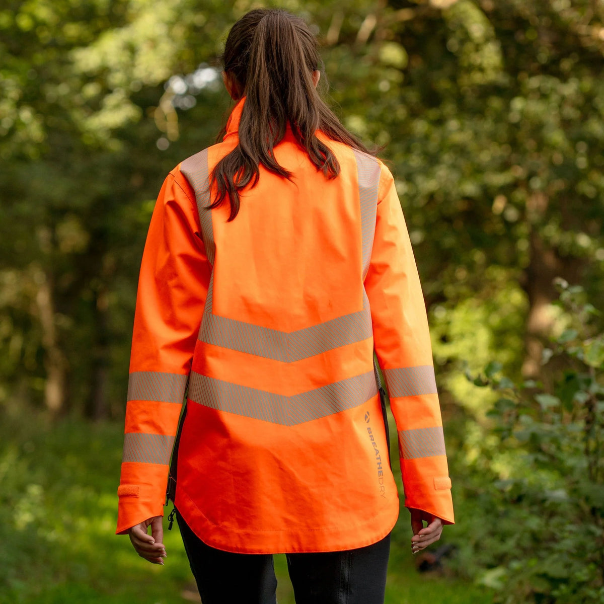 Arbortec ATHV4420 BreatheDry women's high-visibility orange waterproof railway and arborist work jacket with reflective tape detailing