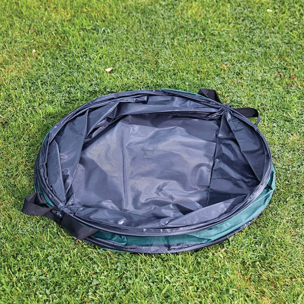 Bosmere green cylindrical pop-up garden refuse bag filled with garden prunings and cuttings on a lawn