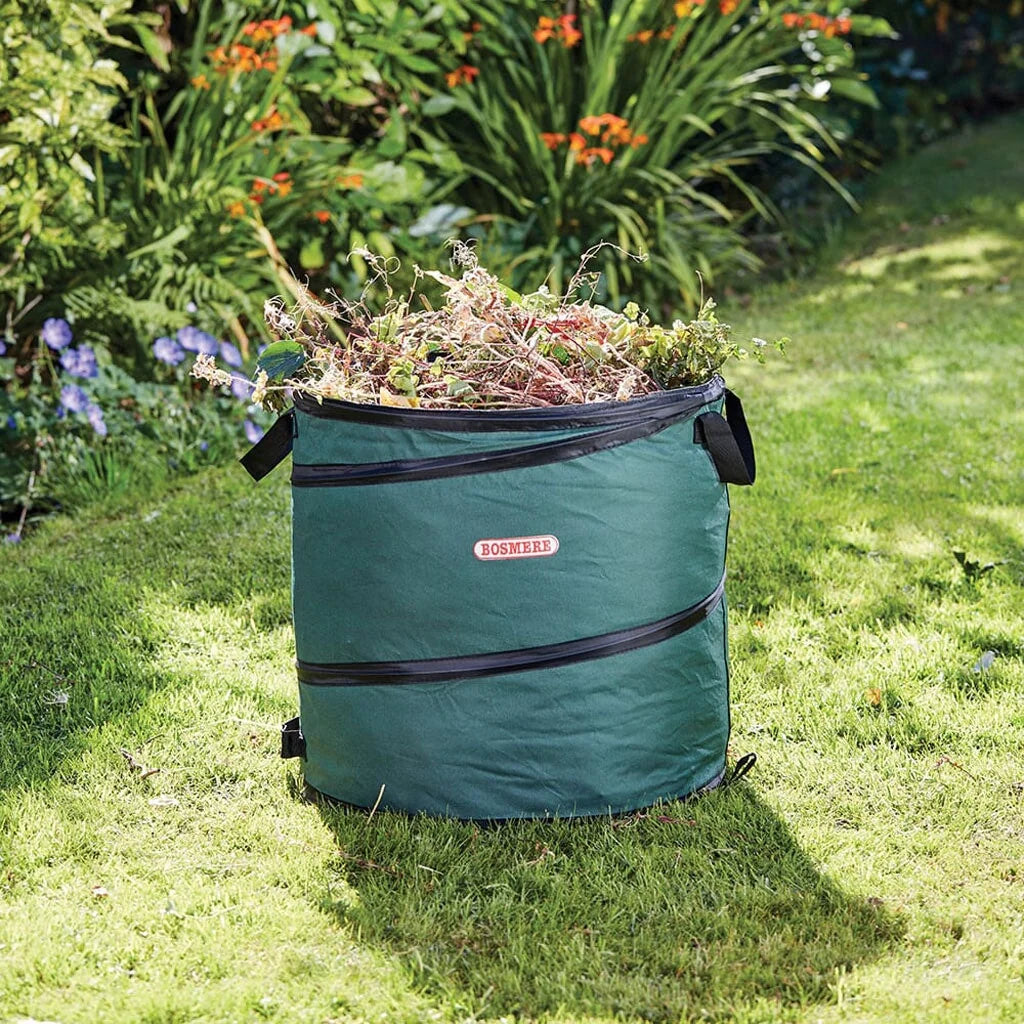 Bosmere green cylindrical pop-up garden refuse bag filled with garden prunings and cuttings on a lawn-2