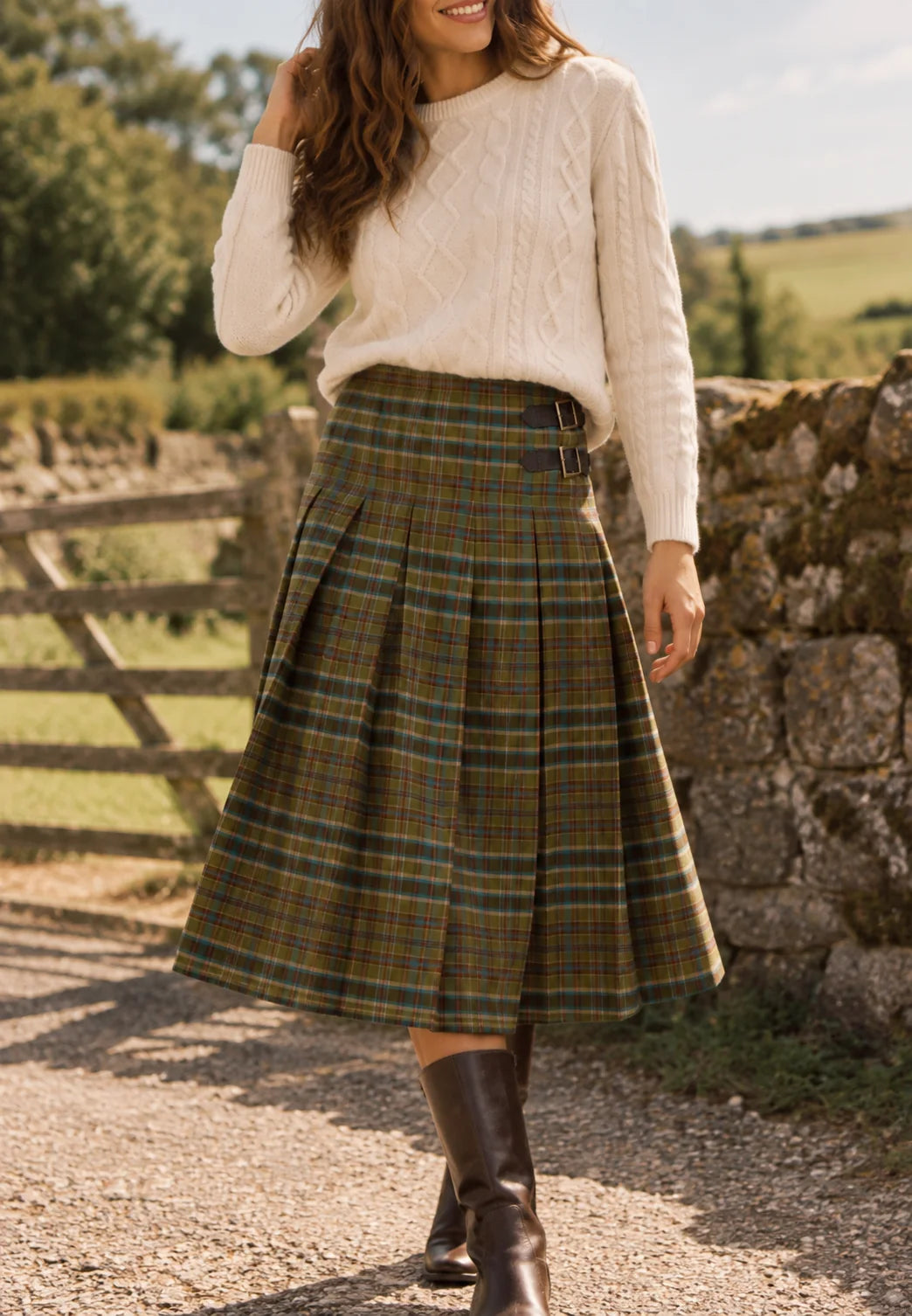 Brakeburn Red Cedar Check Pleated Kilt Skirt styled with a cream cable knit jumper and brown boots